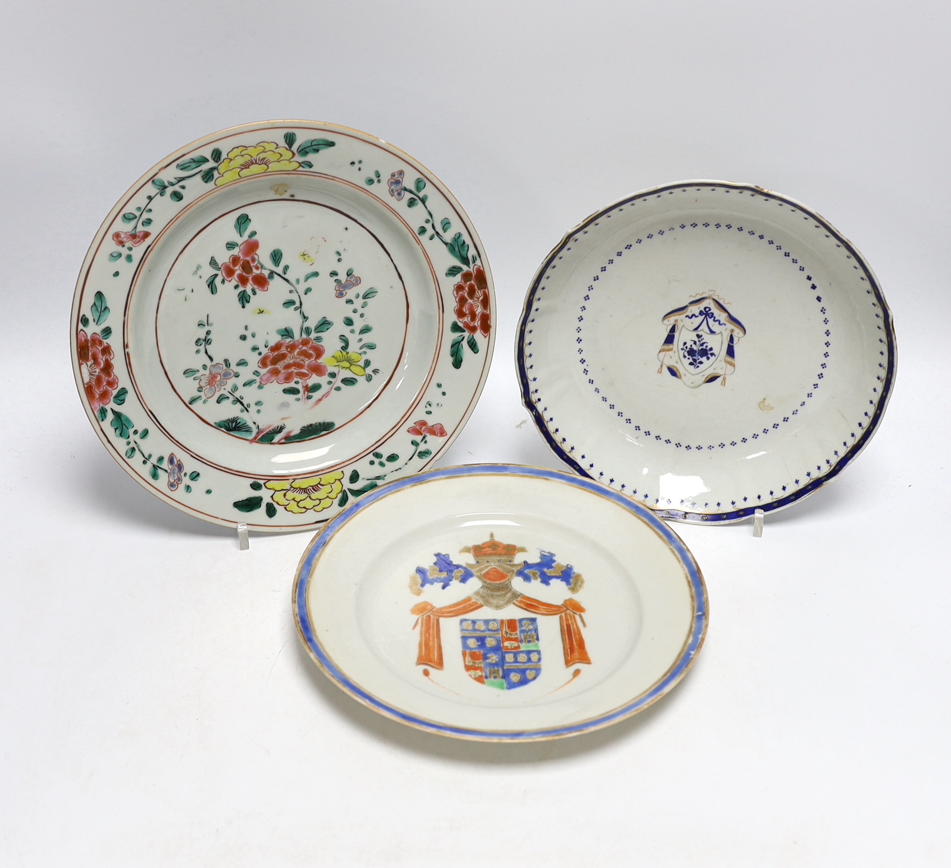 A Chinese famille rose plate together with two armorial or crested dishes, 23cm diameter